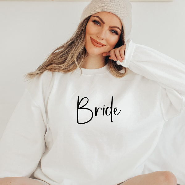 Bride sweatshirts  Looking for a Brides gift? How about a quality, cozy sweatshirt with a Bride design printed on the front of sweatshirt.   Design is available on T-shirt, sweatshirt and Hoodie  Unisex sizing for a relaxed fit. True to fit sizing. Size up for the oversized look. 6 colours - Sand, White, Black, Grey, Pink or Navy
