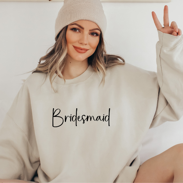 Bridesmaid sweatshirts  Looking for a Bridesmaid gift? How about a quality, cozy sweatshirt, for your bridesmaid proposal printed with a special message saying "Bridesmaid."   Design is available on T-shirt, sweatshirt and Hoodie  Unisex sizing for a relaxed fit. True to fit sizing. Size up for the oversized look. 6 colours - Sand, White, Black, Grey, Pink or Navy 