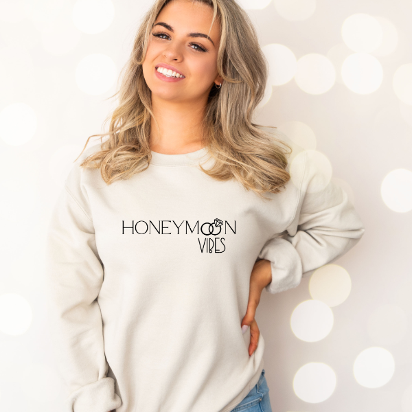 Honeymoon Vibes sweatshirts (CO)  A quality, cozy sweatshirt, printed with the special message "Honeymoon Vibes."   Design also available in T-shirts and Hoodies. Unisex sizing for relaxed fit.  6 colours - Sand, White, Black, Grey, Pink or Navy Crew neck sweatshirt