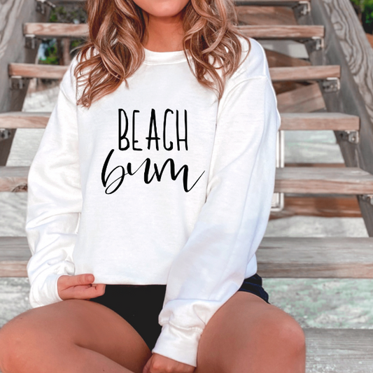 Beach Bum   Design also available in T-shirts and Hoodies. Unisex sizing for relaxed fit.  6 colours - Sand, White, Black, Grey, Pink or Navy Crew neck sweatshirt  Details • Classic Unisex fit • Sizes S - XL • Cotton / Polyester blend for cozy, comfy feel. • 6 colours - Sand, White, Black, Grey, Pink, Navy