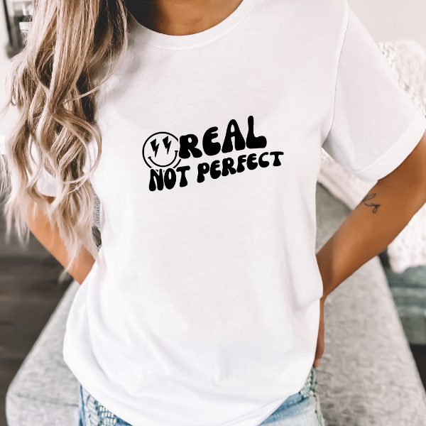 Real not perfect  A great t-shirts with the phrase "Real not perfect" on it.  Our Tees are soft & Comfortable to help you feel cozy and relaxed. They come in several colours and true to fit sizes. (Go up a size for a more oversized, relaxed fit)  Unisex T-shirts - suitable for men and women.