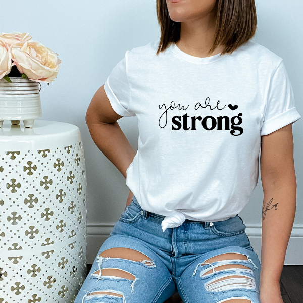 You are Strong T-shirt  Our Tees are soft & Comfortable to help you feel cozy and relaxed. They come in several colours and true to fit sizes. (Go up a size for a more oversized, relaxed fit)  Unisex T-shirts - suitable for men and women.  Colours available - White, Black, Indigo Blue, Military Green, Sand, Natural, Navy, Red, or Grey Tee
