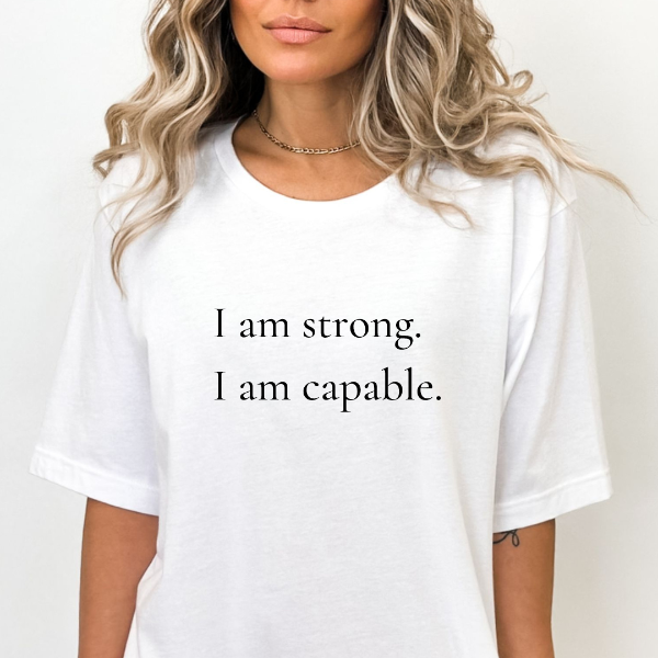 I am strong I am capable  Our Tees are soft & Comfortable to help you feel cozy and relaxed. They come in several colours and true to fit sizes. (Go up a size for a more oversized, relaxed fit)  Unisex T-shirts - suitable for men and women.  Colours available - White, Black, Indigo Blue, Military Green, Sand, Natural, Navy, Red, or Grey Tee