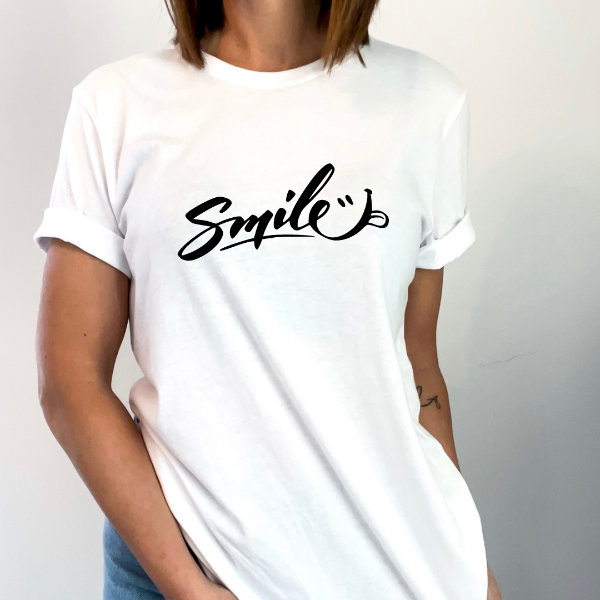 Smile T-shirt  A great good vibes t-shirts with the phrase "Smile" on it.  Our Tees are soft & Comfortable to help you feel cozy and relaxed. They come in several colours and true to fit sizes. (Go up a size for a more oversized, relaxed fit)  Unisex T-shirts - suitable for men and women.